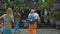 Photo of people walking on the rock stears in a sacred place with ancient stone buildings on the island of bali