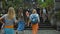 Photo of people walking on the rock stears in a sacred place with ancient stone buildings on the island of bali