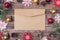 Photo picture close up of craft paper envelope and many lot of christmas accessories on brown wood desk