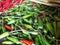 Photo of pile of green chilies on the table