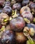 Photo of a pile of purple mangosteen fruits