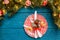 Photo of pine branches, plates with red pattern, prediction cookies, fork, knife, Christmas decoration