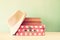 Photo of pink suitcase with polka dots, fedora hat and stack of books