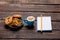 Photo of plate full of cookies, notebook with pencil and cup