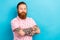 Photo of pleasant good mood man with redhair beard wear stylish pink t-shirt holding hands crossed isolated on blue