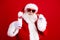 Photo of pleasant grandfather wear stylish santa costume hold glass of milk cookies at christmas eve isolated on red