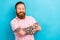 Photo of pleasant handsome man with redhair beard wear pink t-shirt hold arms crossed demonstrate tattoo isolated on