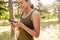 Photo of pleased nice woman using cellphone and smiling