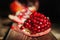 Photo of a pomegranate fruit macro. Pomegranate seeds close-up on a dark background.