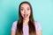 Photo portrait of amazed shocked girl with straight long hair staring with opened mouth isolated on vibrant teal color
