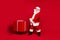 Photo portrait of astonished white haired santa claus pulling sleigh with giant heavy box isolated on bright red colored
