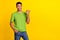 Photo portrait of attracive young guy smiling finger point empty promo space dressed trendy green look isolated on