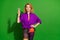 Photo portrait of attractive young girl show v-sign dressed stylish violet garment isolated on green color background