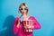 Photo portrait of attractive young woman eat popcorn soda watch movie wear trendy pink knitted clothes  on blue