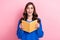 Photo portrait of attractive young woman hold read book impressed bookworm wear trendy blue clothes isolated on pink