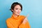 Photo portrait of attractive young woman point empty space offer look banner wear trendy orange garment isolated on blue