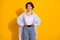 Photo portrait of beautiful female millennial smiling wearing white shirt jeans isolated on vivid yellow color