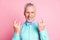 Photo portrait of cheerful grandfather showing heavy metal sign with both hands smiling isolated on pink color