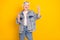 Photo portrait of cool positive granny smiling showing v-sign gesture isolated on vivid yellow color background