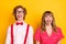 Photo portrait of couple fooling grimacing funny showing tongue isolated on vivid yellow background