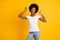 Photo portrait of crazy african american woman pointing two fingers at her hair with open mouth wearing white t-shirt
