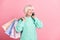 Photo portrait of curious granny talking on cellphone keeping packages looking at blank space isolated on pastel pink