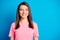 Photo portrait of curious pretty female brunette looking at blank space isolated on vivid blue color background