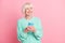 Photo portrait of curious senior woman using cellphone looking at empty space isolated on pastel pink color background