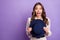 Photo portrait of curious surprised model keeping hat wearing dress amazed looking copyspace isolated on pastel purple