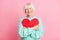 Photo portrait of cute grandmother hugging embracing red heart symbol valentines day isolated on pastel pink color
