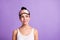 Photo portrait of dreamy curious woman looking empty space in sleeping mask isolated on pastel violet color background