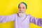 Photo portrait of elder cheerful man taking selfie smiling isolated on bright yellow color background