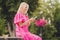 Photo portrait elder woman with blonde hair browsing internet with smartphone sitting in green summer park