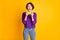 Photo portrait of excited gamer girl holding phone vertically isolated on vivid yellow colored background