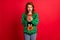Photo portrait of excited girl with open mouth holding phone in two hands wearing ugly green sweater isolated on vivid