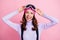 Photo portrait of excited girl touching skiing goggles isolated on pastel pink colored background