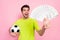 Photo portrait football fan wearing bright t-shirt keeping soccer ball banknotes stack isolated pastel pink color