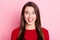 Photo portrait of funny brunette girl grimacing fooling showing tongue smiling isolated on pink color background