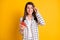 Photo portrait of funny cheerful woman staring amazed using smartphone smiling isolated on vivid yellow color background