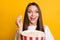 Photo portrait of funny excited smiling girl keeping pop corn carton box watching adventurous film isolated vivid yellow