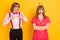 Photo portrait of funny geek amazed charmed with serious girl spending on date isolated vibrant yellow color background