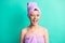 Photo portrait funny woman turban on head spa salon wearing pink towel winking blinking isolated vivid turquoise color