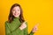Photo portrait girl cheerful showing finger copyspace  vibrant yellow color background