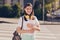 Photo portrait of girl keeping book wearing rucksack yellow headphones smiling going to college