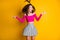 Photo portrait of goofy girl jumping with silly ponytail with raised hands wearing fuchsia crop-top isolated on bright