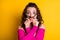 Photo portrait of goofy girl making hair mustache pouting holding with two hands wearing casual pink crop-top isolated