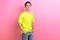 Photo portrait of handsome teen male hands pockets model shopping dressed stylish yellow garment isolated on pink color