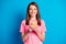 Photo portrait of happy female student keeping mobile phone smiling isolated on bright blue color background