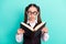 Photo portrait little girl wearing glasses amazed shocked reading book isolated pastel turquoise color background