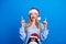 Photo portrait of lovely blonde young lady pointing up look empty space wear penguin sweater x-mas hat  on blue